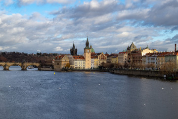 Prague, Czech Republic, Europe, panorama overlooking the historic buildings of Prague Castle, Charles Bridge and the Vltava River in front of interesting blue sky with clouds