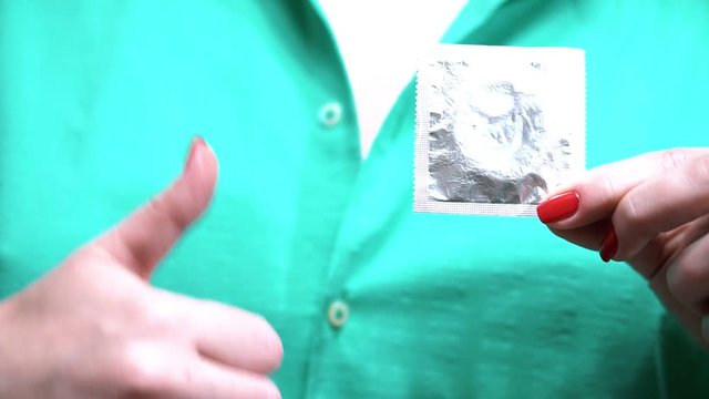 condom in hand girl. Safe sex concept