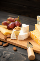 Various types of cheese on a rustic table