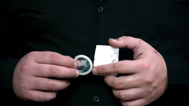 Men unboxing condom. Safe sex concept