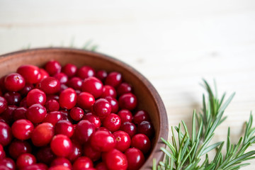 Cranberries on wooden background. Background with cranberries. Useful berries