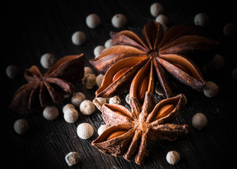  star anise, white pepper, on a dark background