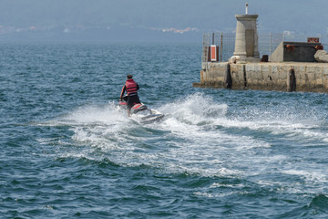 young man riding a jet ski in the sea