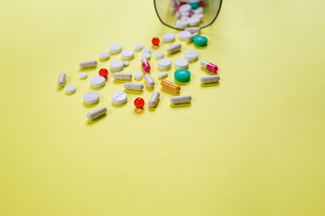 Control, support, Pill on yellow background. Colored Pills And Capsule isolated. Pharmacy Theme,Medicine Antibiotic.Multi-colored tablets and capsules, bottle for tablets, pharmaceutical medicine