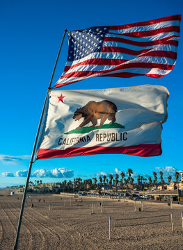 US and California state flag fluttering on huntington beach, vivid colour effect
