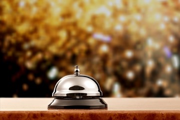 Vintage hotel reception service desk bell on blue wall