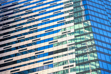 Windows of under construction high-rise building, view of modern glass and concrete exterior of high rise building