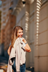 Fototapeta premium Young attractive woman posing on the street.