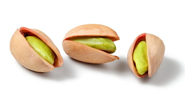 Three Turkish Red Pistachios (Antep), Isolated On White Background. Peeled Green Nuts Visible Inside.