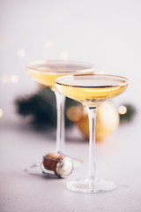 Two champagne glasses, cork and Christmas decorations