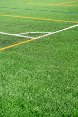 Soccer field with a new artificial turf field, white corner marking. Close up. Soccer background. Copy space