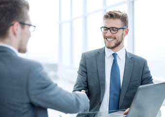 close up.smiling business people shaking hands in office