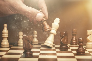Businessman playing chess close up