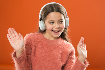 Girl child listen music modern wireless headphones. Listen for free. Get music account subscription. Access to millions songs. Enjoy music concept. Keep hands free with wireless modern technology