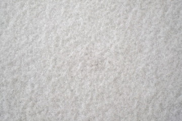 White sleet & snow on ground for background.