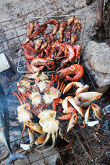 Grilled seafood, delicious prawn, crab, octopus, mussels, closeup of charcoal stove, beach picnic, gifts of the INdian ocean, perfect