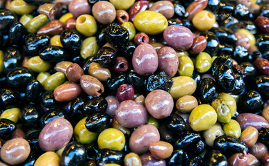 Mixed marinated olives green, black and purple in a street market in Tel Aviv, Israel