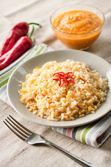Spicy parboiled rice with carrots, yellow zucchini and chili peppers