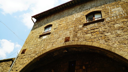 Ancient Viterbo stone building seen from below that resembles a face, in a sunny day