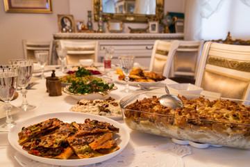  very nicely prepared dining table for special, valentines' day or Ramadan or Christmas in the luxury living room. Pasta,macaroni,salads,pizza on the table for party time.