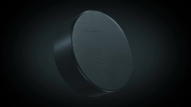 Beautiful Hockey Puck Turning on Black Background in Looped 3d animation with Green Screen Alpha Mask. Active Sport Concept. 4k Ultra HD 3840x2160.