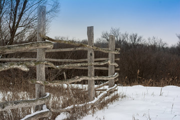 fence in the village in winter