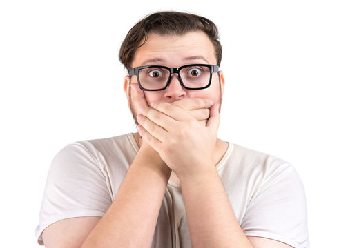 Shocked man covering mouth in fear