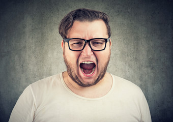 Screaming chunky man in eyeglasses