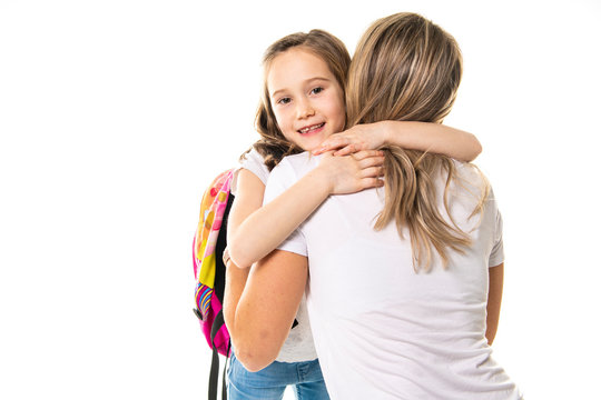 A Mother hugging her little daughter and saying good-bye on the first day of school