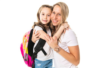 A Mother hugging her little daughter and saying good-bye on the first day of school