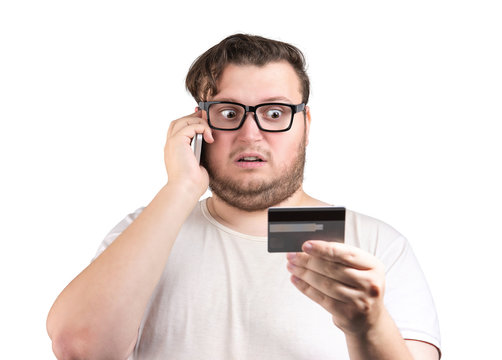 Shocked man with card speaking on phone