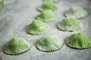 Green ravioli on table