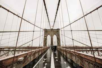 Obraz na płótnie Canvas The Brooklyn bridge, New York City, USA. Rainy day in New York.