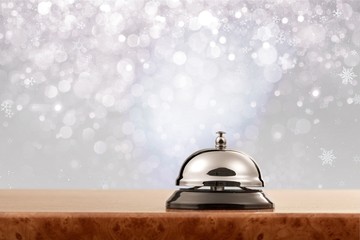 Vintage hotel reception service desk bell on blurred background