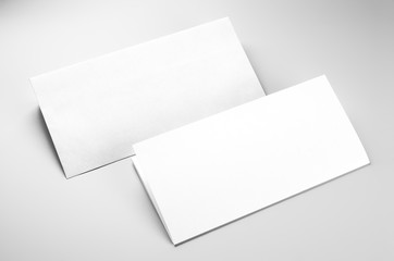 Blank envelope and folded letterhead over gray background
