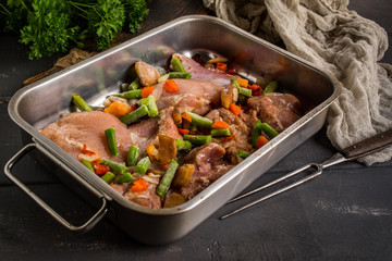 Prepared for baking chicken meat with vegetables.