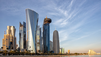 DOHA, QATAR - 31 January 2016: Skyscrapers in the Dafna district of Doha t sunset, with the Sheraton hotel on the right, - obrazy, fototapety, plakaty