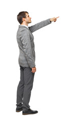 Back view of pointing business man. gesticulating young guy in s