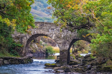 Fototapeta na wymiar Old Weir Bridge, Meeting of the Waters, where the three Killarney lakes (Upper, Muckross and Lough Lane) meet Killarney National Park, County Kerry, Ireland.