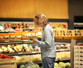 Young man buying vegetables at the market