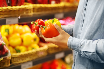 Young man buying vegetables at the market