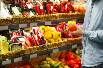 Young man buying vegetables at the market