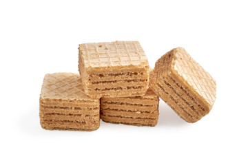 pile of chocolate square honey wafer biscuits isolated on white