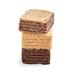Stack of assorted square wafer biscuits isolated on white backdrop.