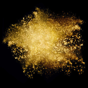 Golden glitter explosion. Dust particle isolated on black background