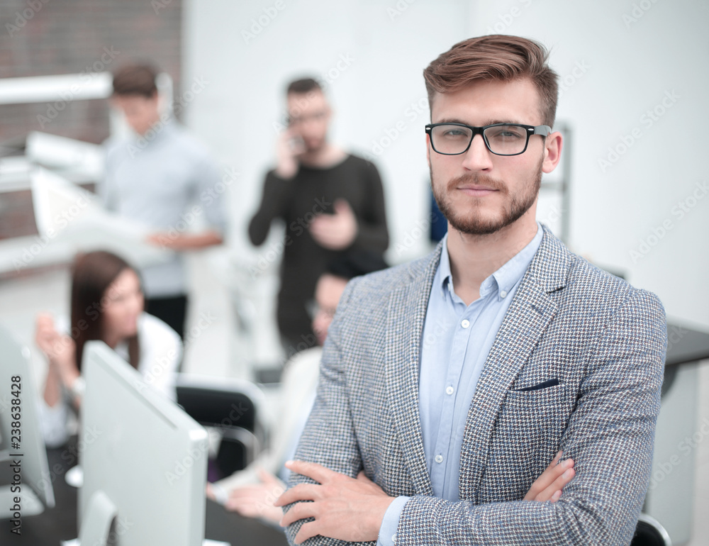 Wall mural confident young businessman on the background of the office