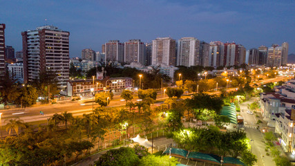 Obraz premium Aerial view of the city buildings at night, with the lights of the streets accessed