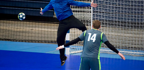handball player trying to give a goal during a game - obrazy, fototapety, plakaty