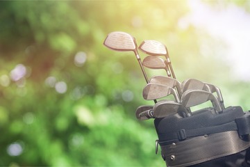 Different golf clubs on  background.