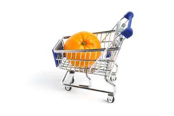 Ripe, juicy tangerine lies in the supermarket trolley on a white background. Conceptual photo